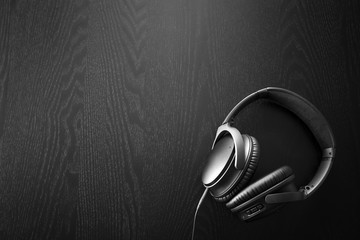 Image of headphones isolated on black background illuminated by spotlights.