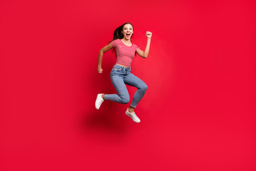 Full length body size trendy photo of crazy winning victorious girl wearing jeans denim crazily running towards shopping mall while isolated with red background