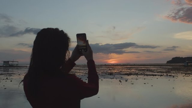 Back Shot Of A Millennial Girl Taking A Photo Of Sunset  4K