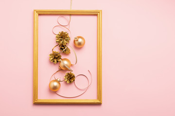 New Year Christmas frame layout balloons streamers shiny cones of gold color pink background. Holiday concept. Flat lay.