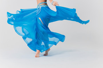 Portrait of belly dancer girl in blue. isolated on white.