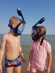 couple with snorkeling equipment on the beach
