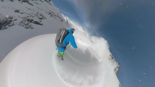 VR 360: Two unrecognizable snowboarders shredding the fresh powder on a sunny day. Extreme snowboarders carving down the untouched mountain in the picturesque Rocky Mountains. Awesome winter sport