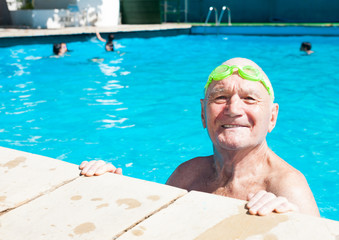 happy old man posing in swimming pool