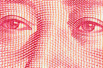 Macro close up photograph of Mao eyes detail on the Chinese Yuan currency note.  