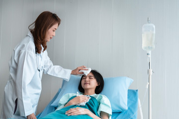 Fototapeta premium A doctor is taking care of a sick young woman with seasonal infections flu