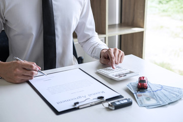 Man client calculating insurance premium for decide signing rental contract form of renting a vehicle agreement, car insurance concept