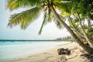 People walking on the beach at Kuto Bay on the Isle of Pines in New Caledonia, South Pacific Ocean.