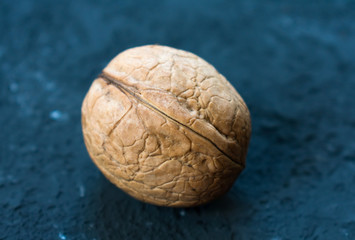  Inshell walnuts close-up on a black background.
