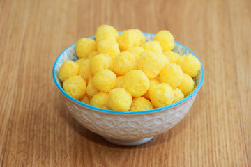 round yellow natural corn balls for breakfast in a ceramic plate