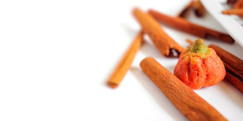 Pumpkin cookies on white background, Halloween gingerbread cookies with cinnamon sticks spices for trick or treat party holiday with copy space