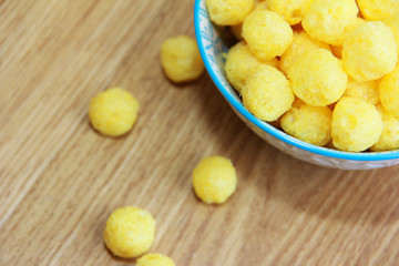 Naklejka na ściany i meble round yellow natural corn balls for breakfast in a ceramic plate
