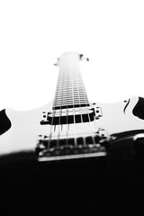 Black and white abstract silhouette of a guitar on a white background.