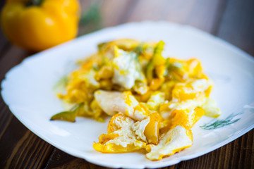 fried omelet from homemade eggs with sweet yellow pepper in a plate