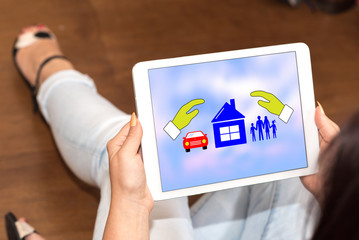 Family, home and car insurance concept on a tablet