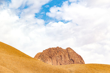 Peak of Spitzkoppe hiding behind a boulder, Erongo, Namibia, Africa