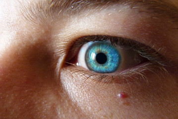 Fototapeta premium Deep blue eye watching into the abyss, blond haired