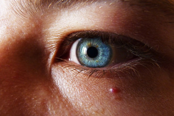 Fototapeta premium Deep blue eye watching into the abyss, blond haired