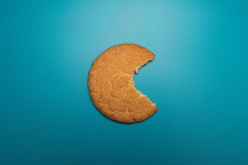 Cookies studio image. Appetizing cookies on a blue background. Bitten biscuits.