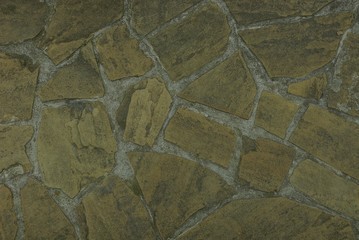 Gray brown texture of a stone wall of an old house