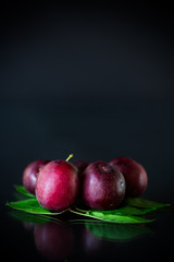 organic red ripe cherry plum isolated on black