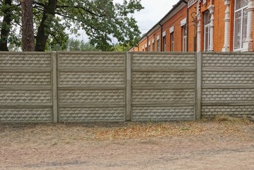  gray fence on a rural street in the grass