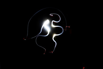Freezelight. Drawing light in the dark. Round scribbles at night.