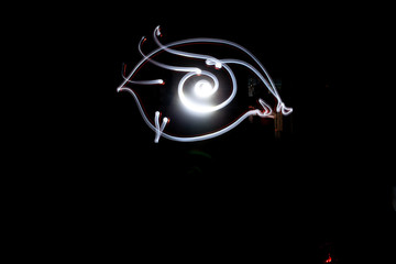 Freezelight. Drawing light in the dark. Round scribbles at night.