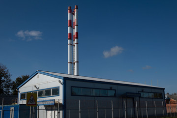 Pipes of a gas boiler room on a clear sunny day.