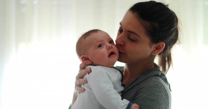 Mom consoling baby infant in causal candid authentic moment