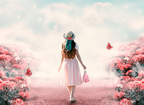 Young lady woman in romantic dress, hat with bag in retro style walking along summer rose field path and flying butterfly. Idyllic tranquil fantasy scene. Travel across fairy tale hills