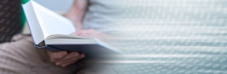 Man reading a book; panoramic banner
