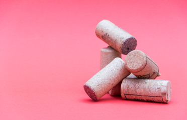 Wine corks with corkscrew on red background. Free copy space.
