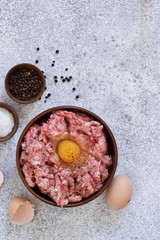 Cooking process minced meat with spices and eggs on the kitchen table. View from above.