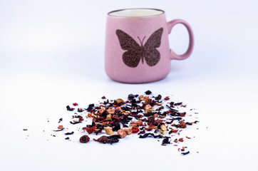 Dry fruit tea on a light background with a pink cup