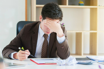 Businessmen feel stressed and tired sitting at his office with a laptop,mobbing concept