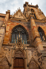 Fototapeta premium Colmar in Alsace, France. Perspective of the Collegiate Church of San Martino, one of the symbols of the city on the canals, also famous for the production of Riesling, Gewurztraminer, Muscat, Pinot.