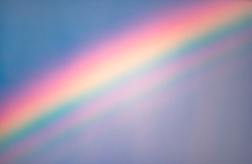 Cloudy sky after rain. Close-up of rainbow.