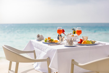 Luxury breakfast food on white table, with beautiful tropical sea view background, morning time summer holiday and romantic vacation concept, luxury travel and lifestyle