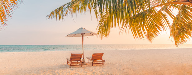 Beautiful tropical beach banner. White sand and coco palms travel tourism wide panorama background concept. Amazing beach landscape. Chairs on the sandy beach near the sea. Summer vacation concept