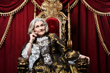 Fototapeta premium Portrait of beautiful senior queen on throne