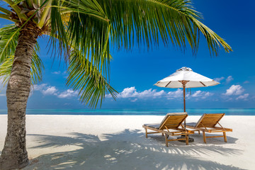 Luxury beach resort, beach loungers near the sea with white sand over sea Topical island background, summer vacation concept, holiday and tourism design. Exotic landscape, inspirational leisure banner