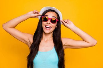 Photo of cheerful charming cute nice attractive relaxing girl wearing eyeglasses sunglass cap turquoise tank-top smiling toothily rejoicing with having gone on vacation isolated vibrant color