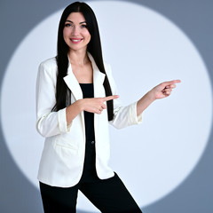 Portrait of a pretty brunette girl with long manager hair in a light business suit in a circle of...