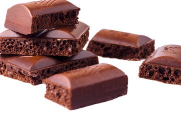 Slices of milk chocolate on a white background