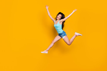 Fototapeta na wymiar Full length body size photo of excited ecstatic overjoyed teenager running quickly towards shopping mall wearing jeans denim shorts teal singlet isolated vivid color background