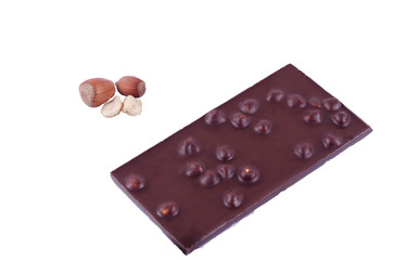 Milk chocolate with whole hazelnuts on a white background