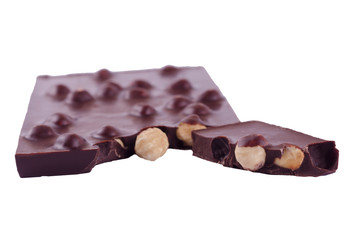 Dark chocolate with whole hazelnuts on a white background