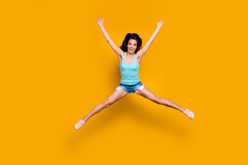 Fototapeta na wymiar Full length body size photo of cheerful cute ecstatic rejoicing girl having won competition and jumping up with happiness doing splits isolated over vivid color background