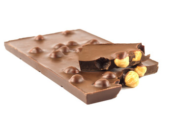 Black chocolate with hazelnuts on a white background
